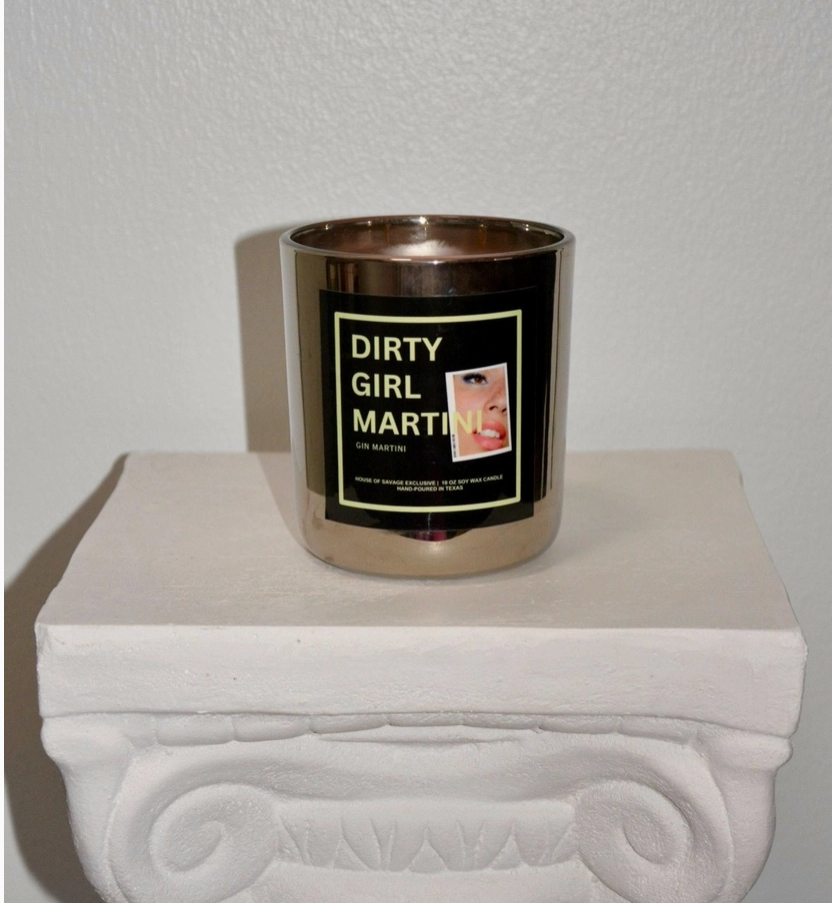 Silver candle holder with a black label on a white surface
