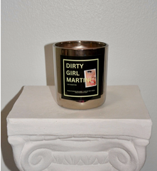 Silver candle holder with a black label on a white surface