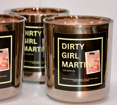 Candle containers labeled 'Dirty Girl Martini' with a black label featuring a woman's face.