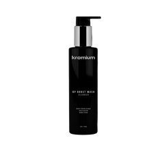 A black cylindrical pump bottle labeled 'kromium' and 'VIVID WASH CLEANSER' stands centered on a dark marble-patterned pedestal against a black background.