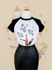 Black and white baseball shirt with clown graphics on a mannequin against a beige background.