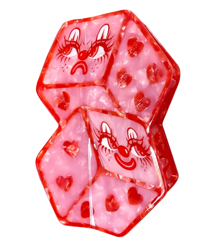 Pink and red dice with cartoon faces on a white background