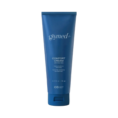 A blue squeeze tube of glymed+ Comfort Cream with face & body, shown on a light gray background with a soft shadow.