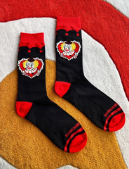 Black socks with red accents featuring cartoon character designs on a textured surface.